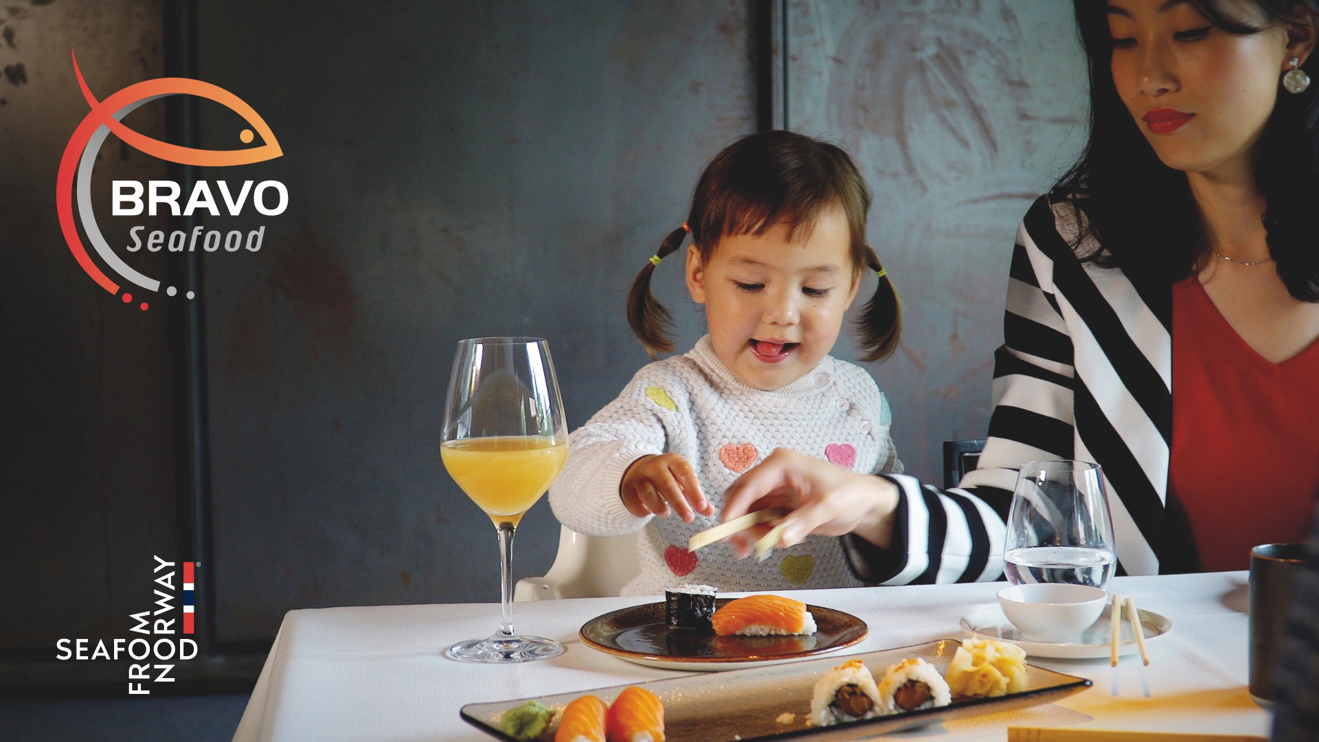 Little girl eats sushi with salmon provided by Bravo Seafood